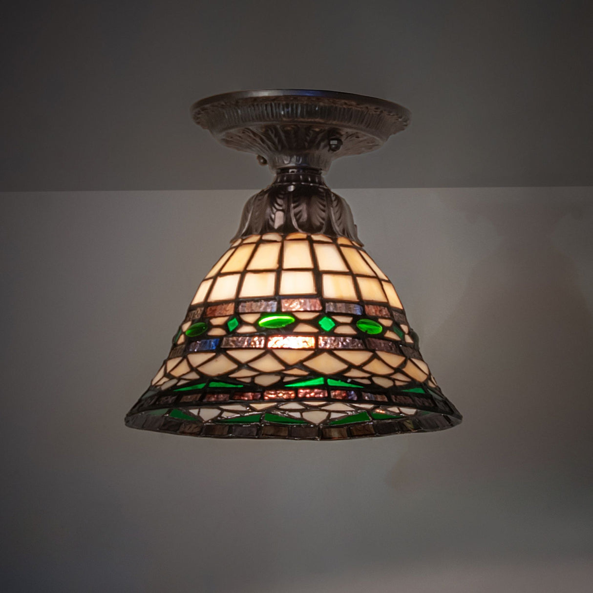 Tiffany-style ceiling light with a green shade, ideal for dining and living areas.