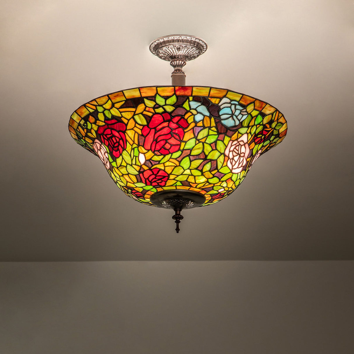 Illuminated Tiffany Rosebush semi-flushmount showing vibrant colors.