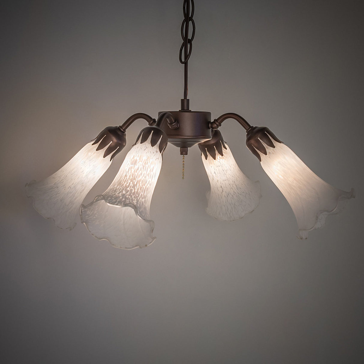 Illuminated Tiffany Pond lily fan light fixture with elegant glow.