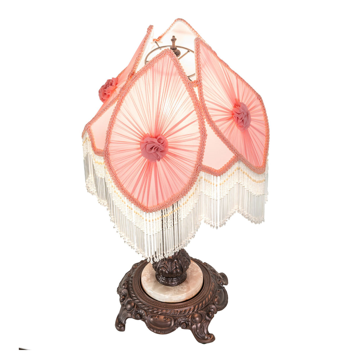 Top view of pink lampshade with floral accents and intricate fringe.
