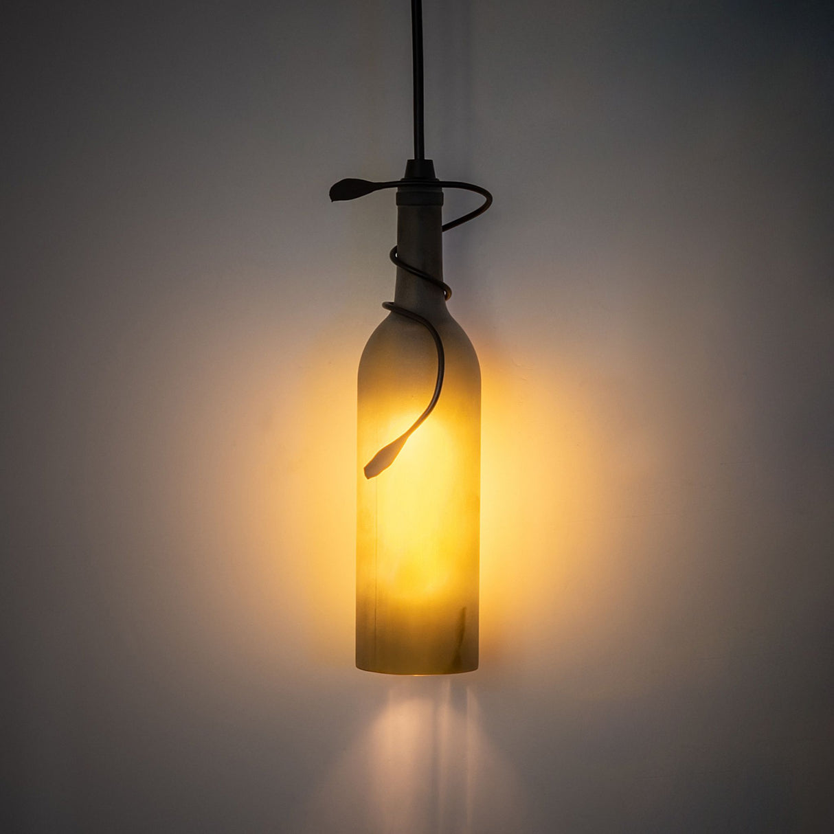 Illuminated Tuscan Vineyard wine bottle pendant casting warm glow.