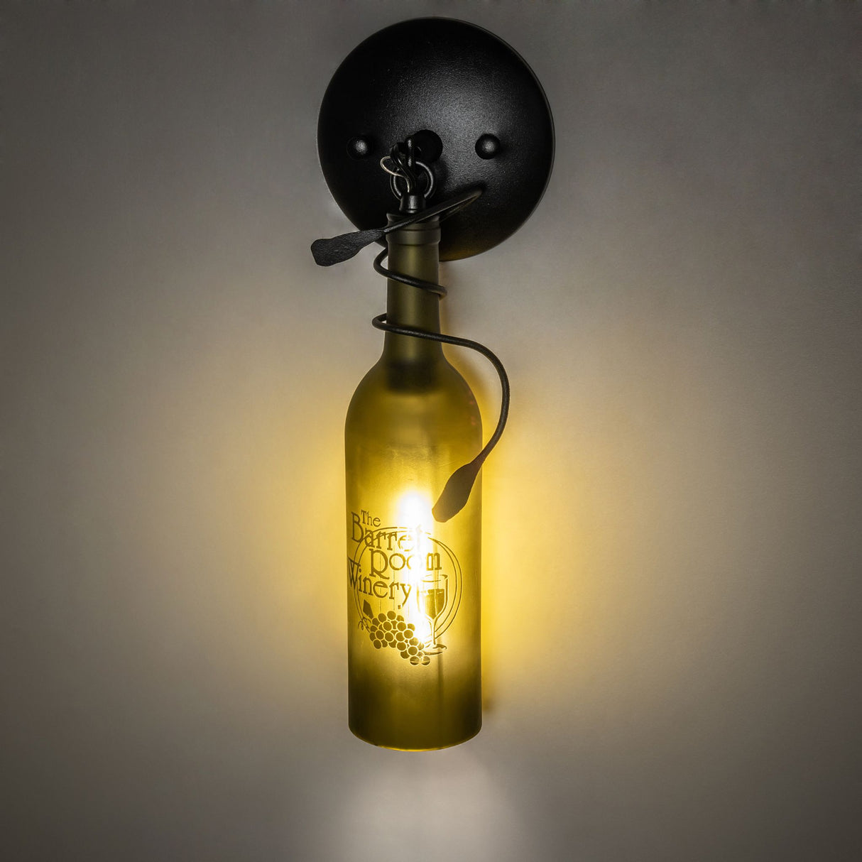 Glowing green wine bottle wall sconce with warm light.