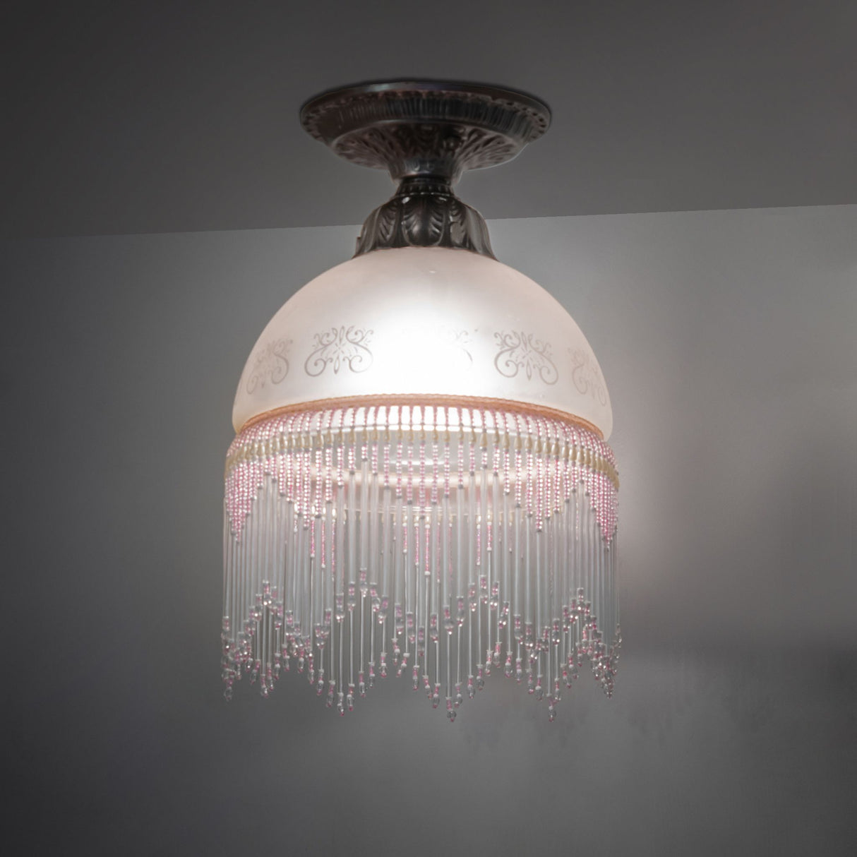 illuminated dark view of victorian roussillon flushmount showcasing elegant glass design.