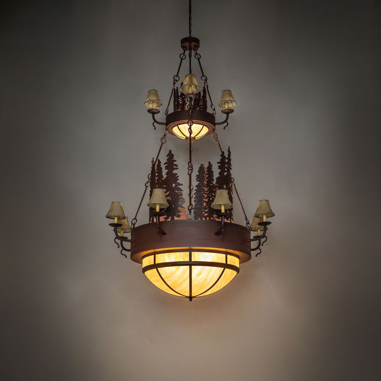 Room view of the Walden Pine chandelier illuminated by its bottom amber dome lights.