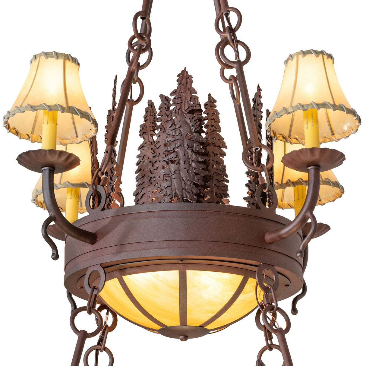Closeup focusing on rustic pine tree metalwork and candle fixture design.