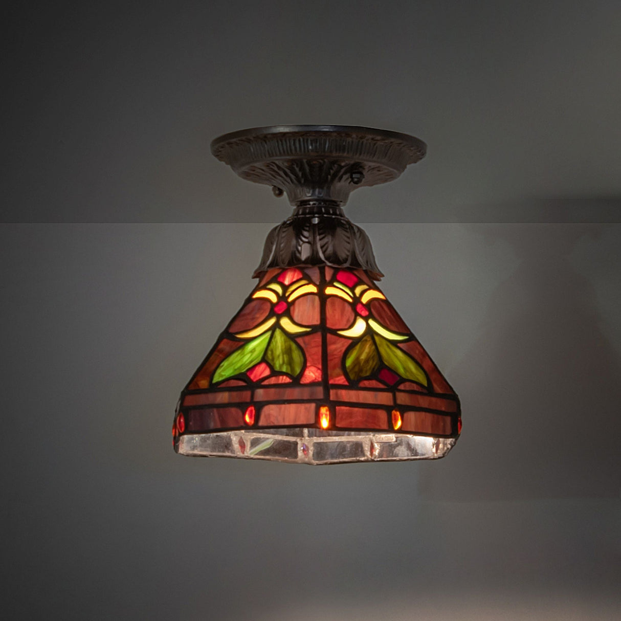 Warm stained glass flushmount ceiling fixture.
