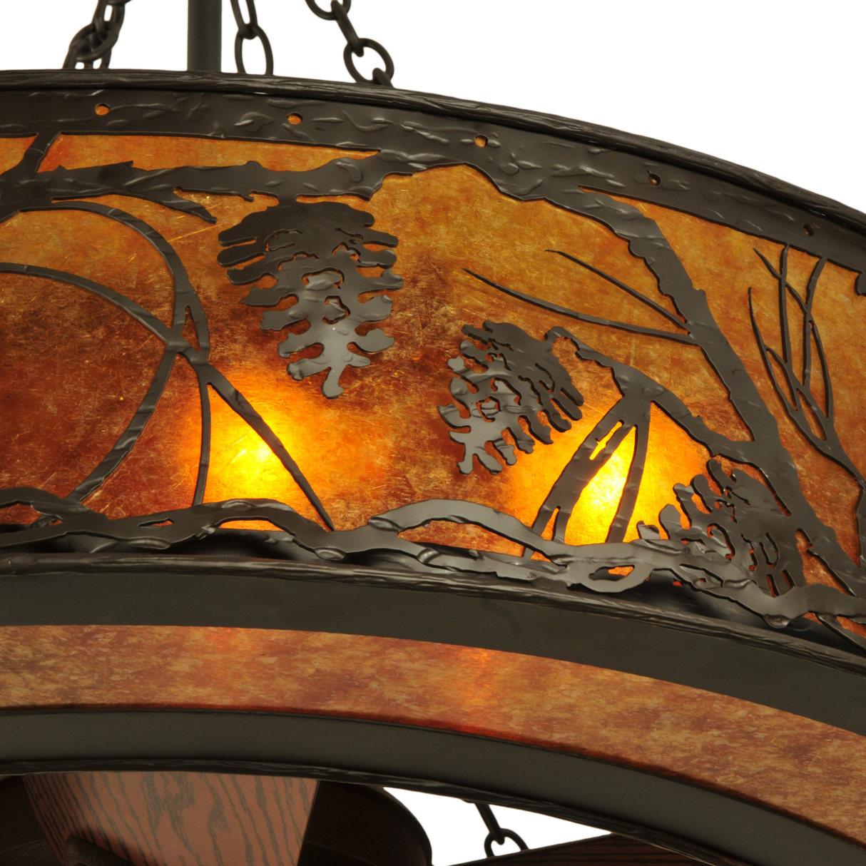 Close-up of pinecone metal art with soft amber mica backlight.