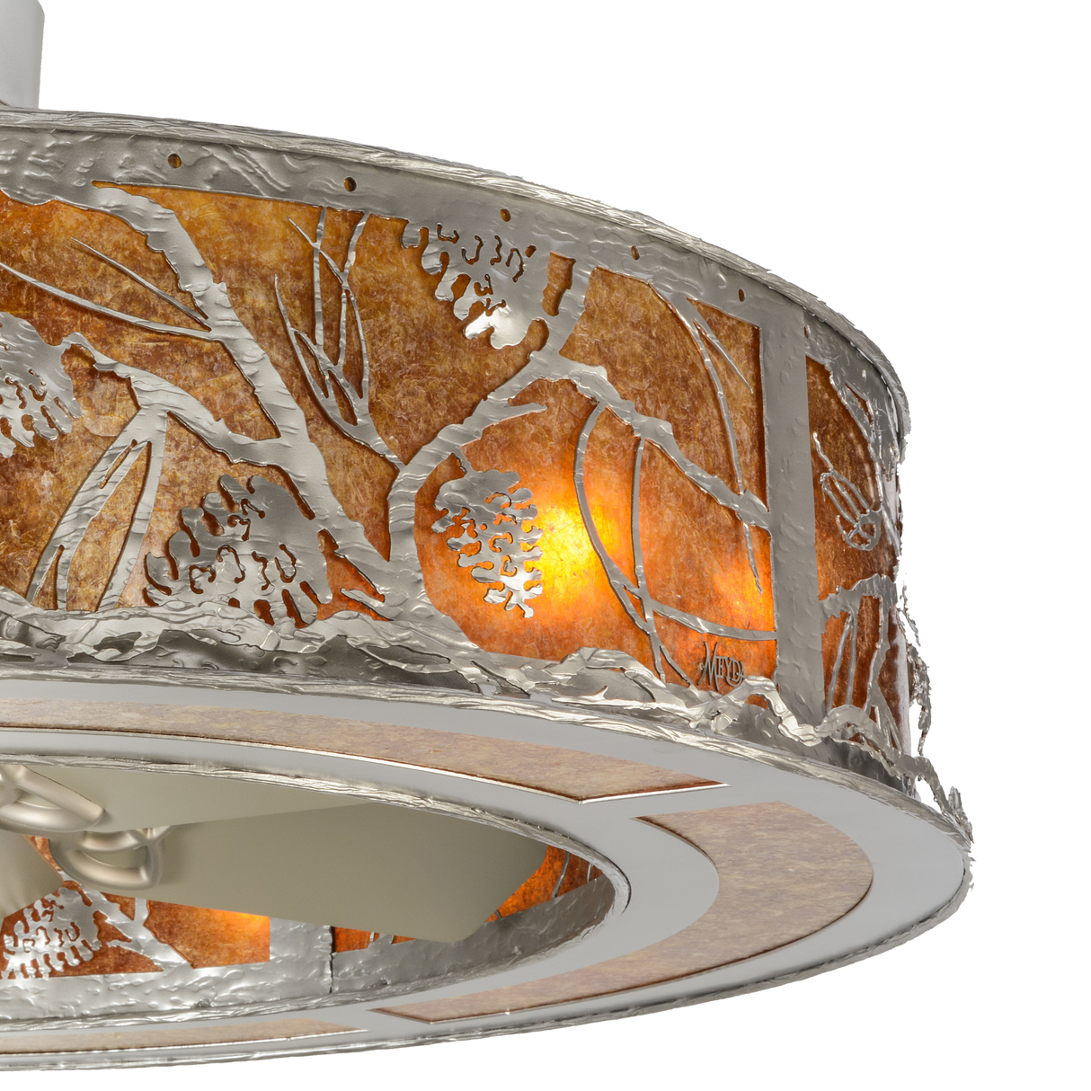Closeup showing illuminated pinecone design and hammered metal edge.