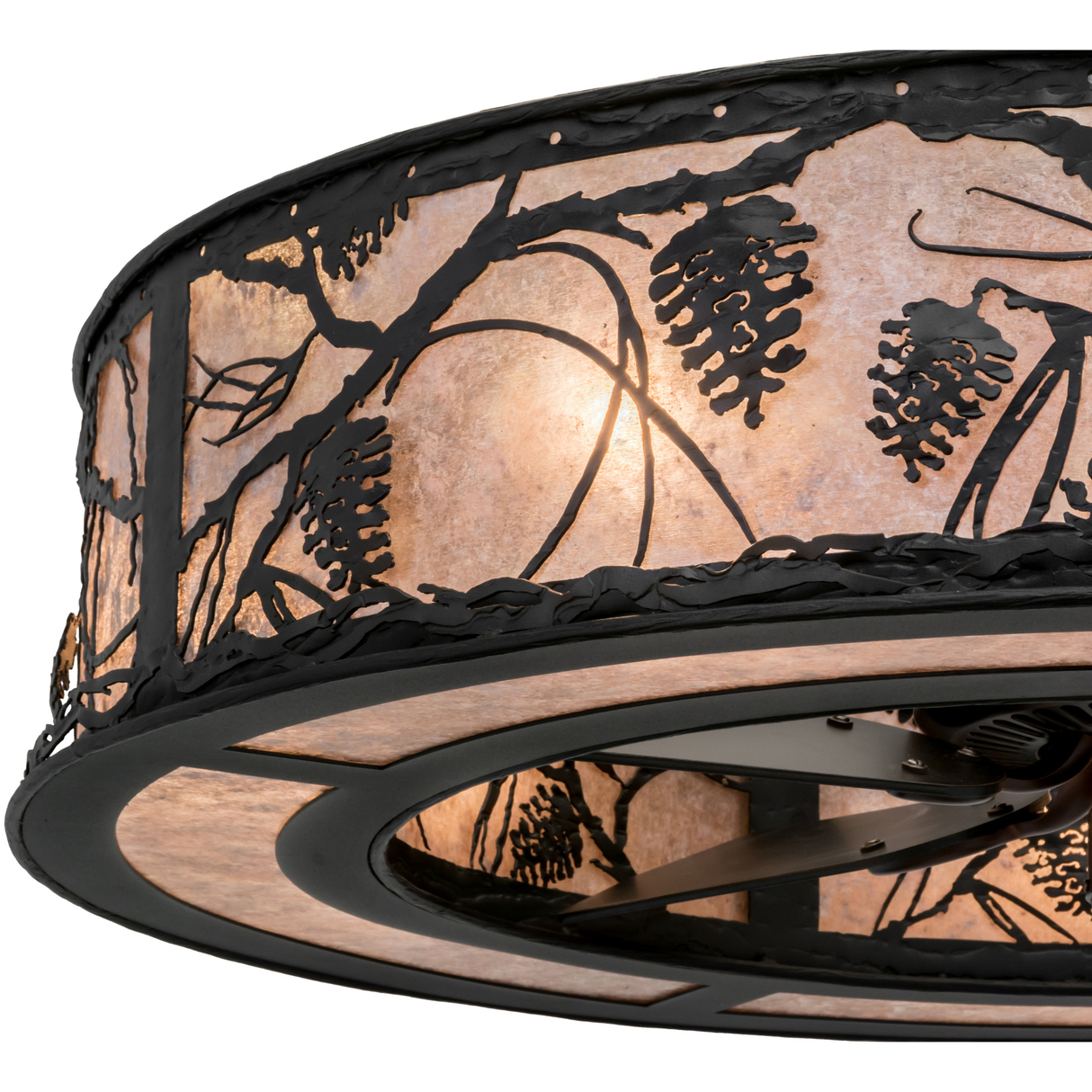 Close-up lit view showcasing detailed pinecone cutouts and glowing mica texture.