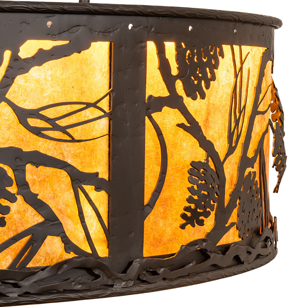 Close-up of handcrafted pinecone branch metalwork on amber mica shade.