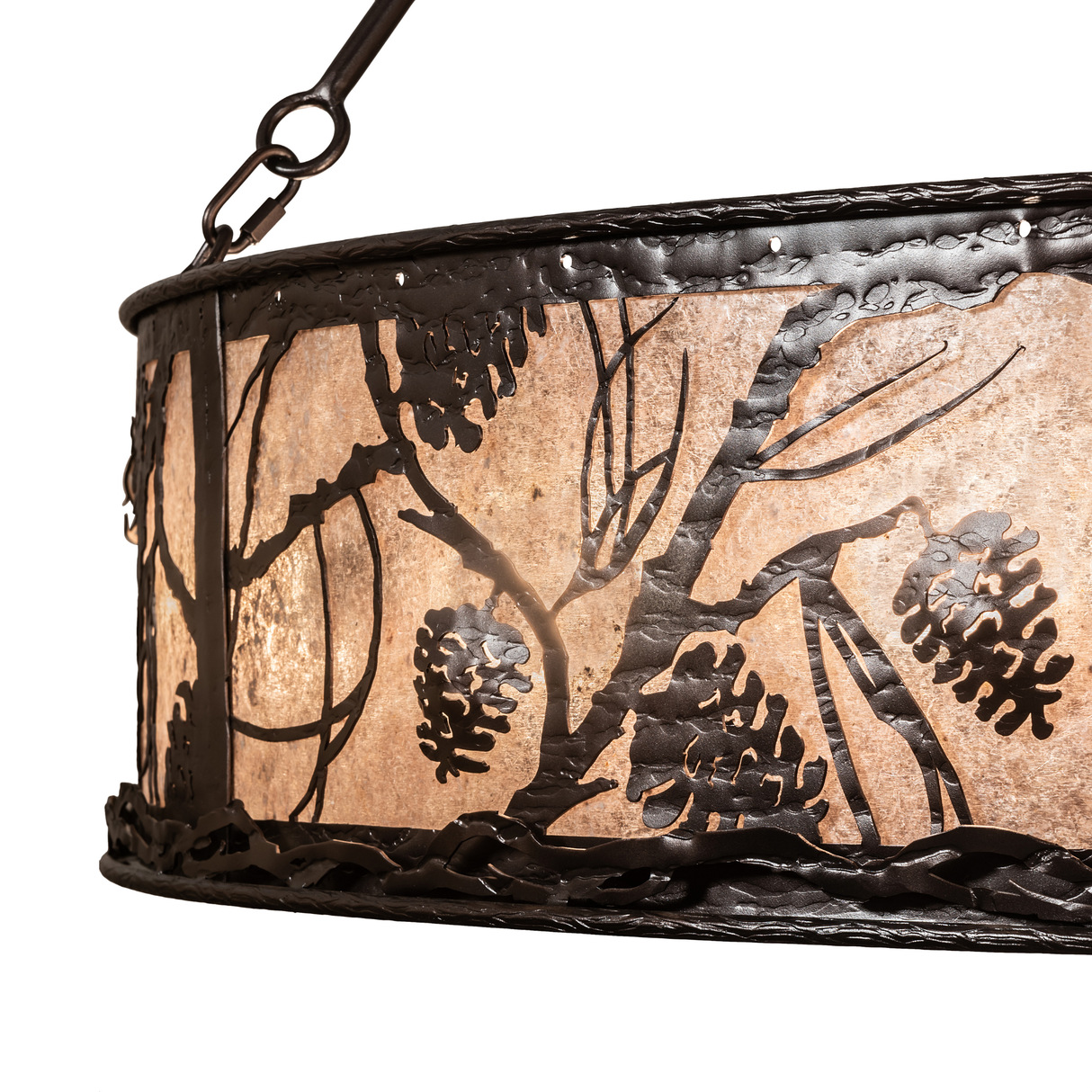 Close-up of silver mica panel with pinecone and branch cutout detail.