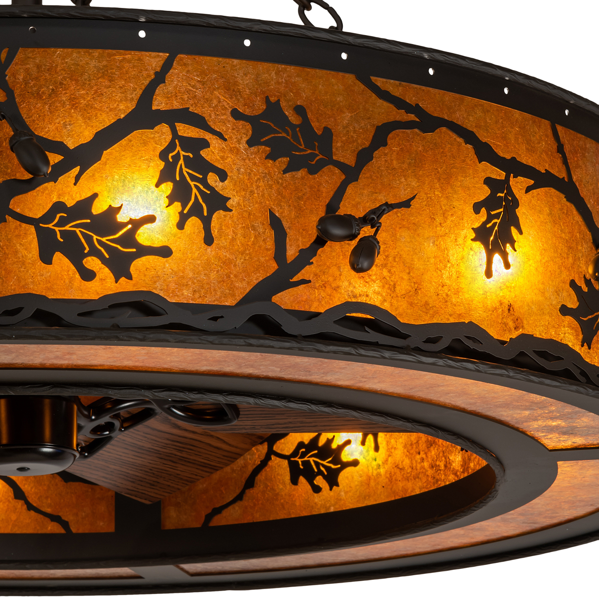Close-up of oak leaf and acorn metalwork illuminated through amber mica.