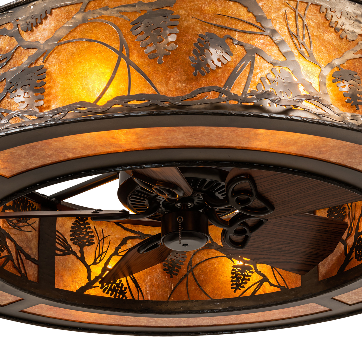 Close-up of wooden fan blades and hub with amber illumination.