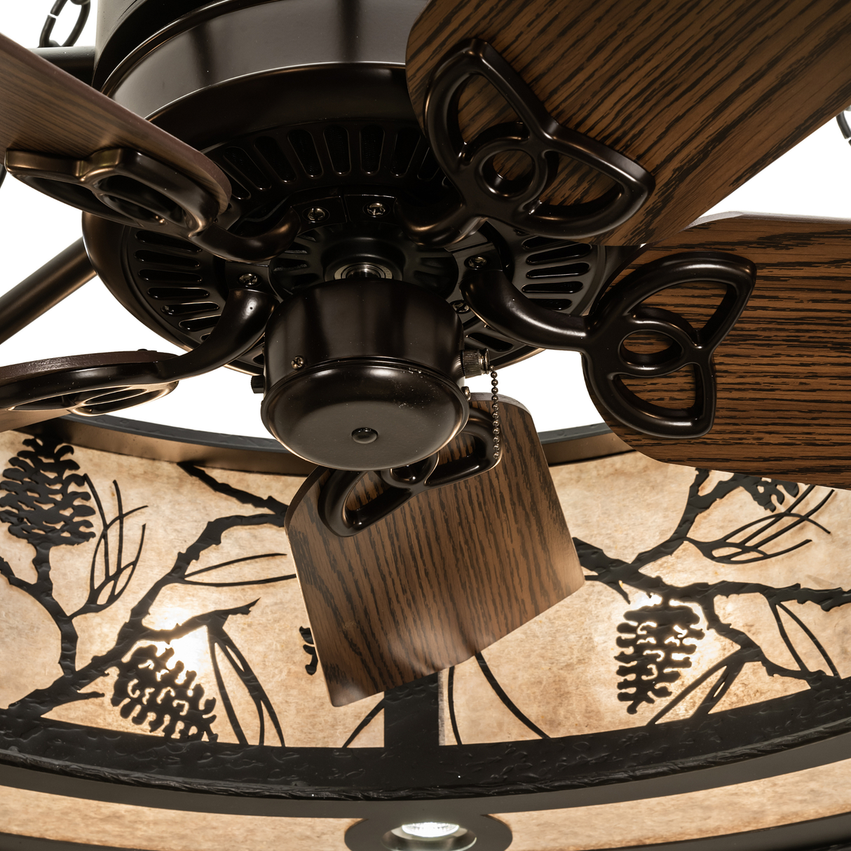 Close-up of fan motor and wooden blades inside illuminated frame.