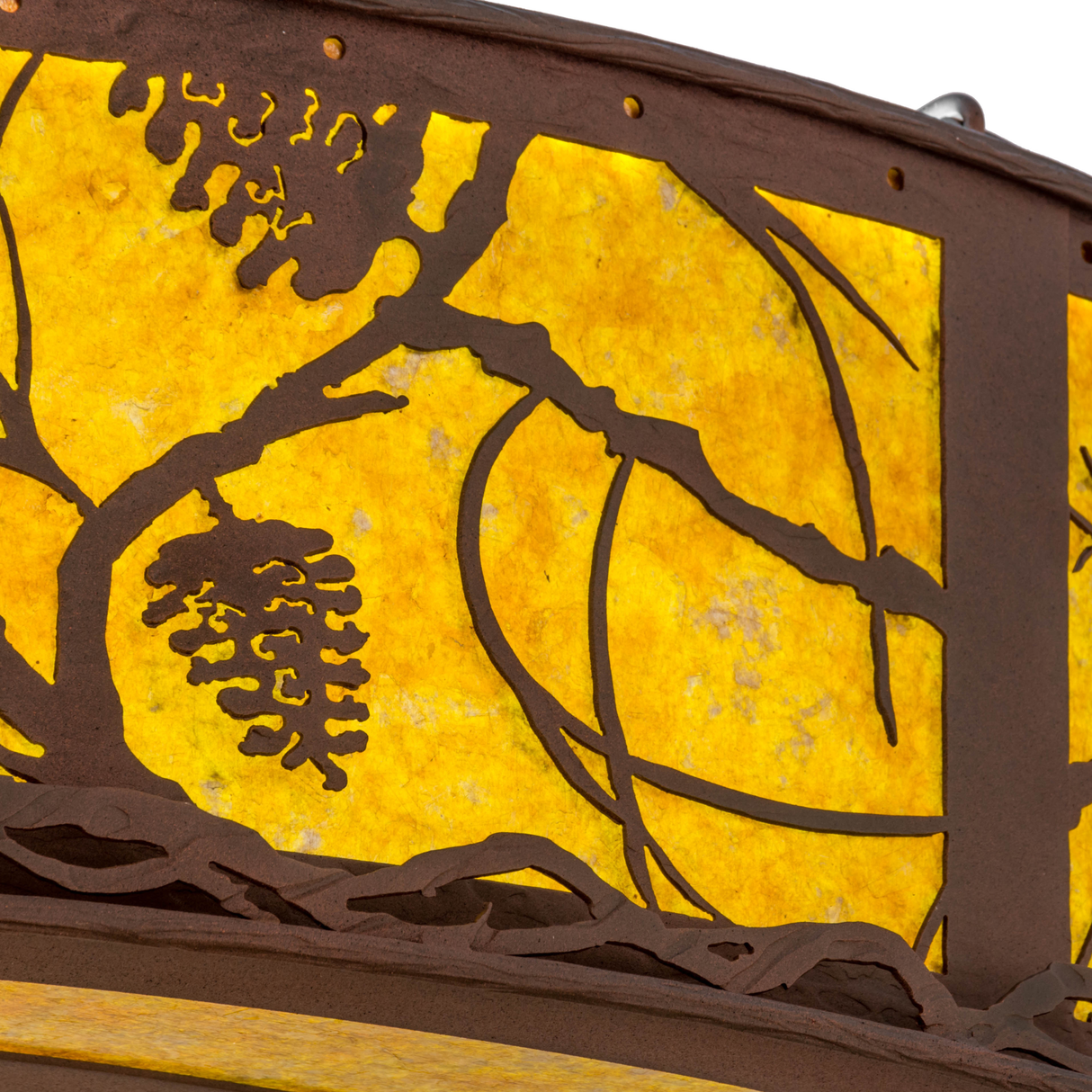 Shade detail showing textured pine branch and cone design.