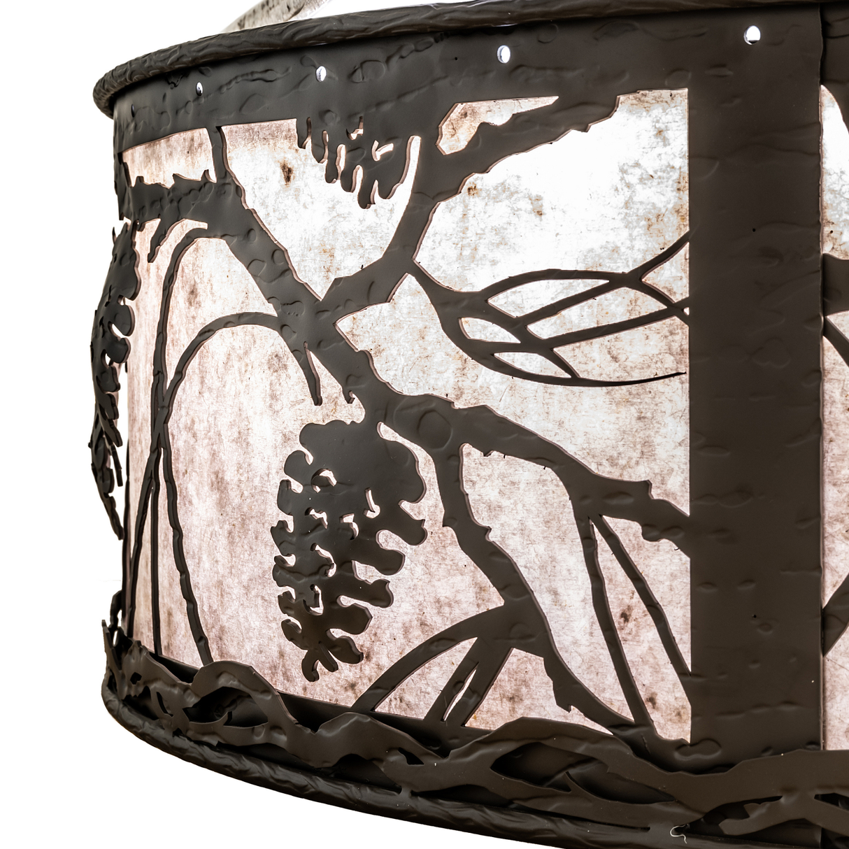 Detailed view of bronze pinecone cutouts on mica diffuser.