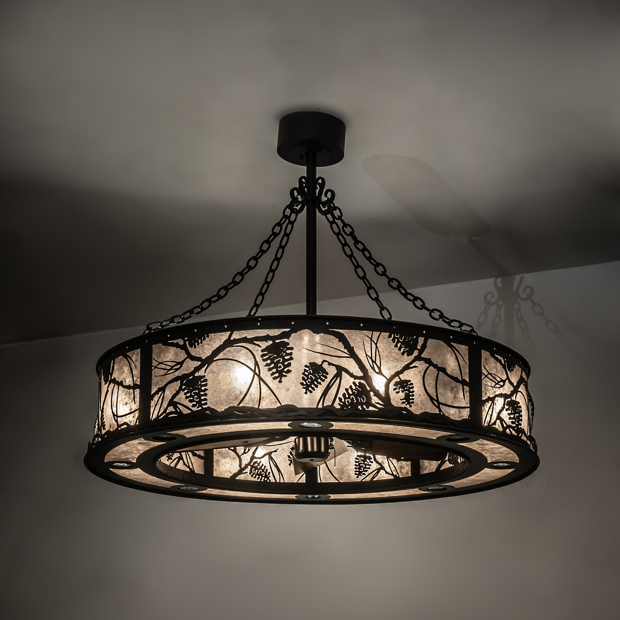 Warmly illuminated ambient view highlighting pinecone and branch cutout pattern.