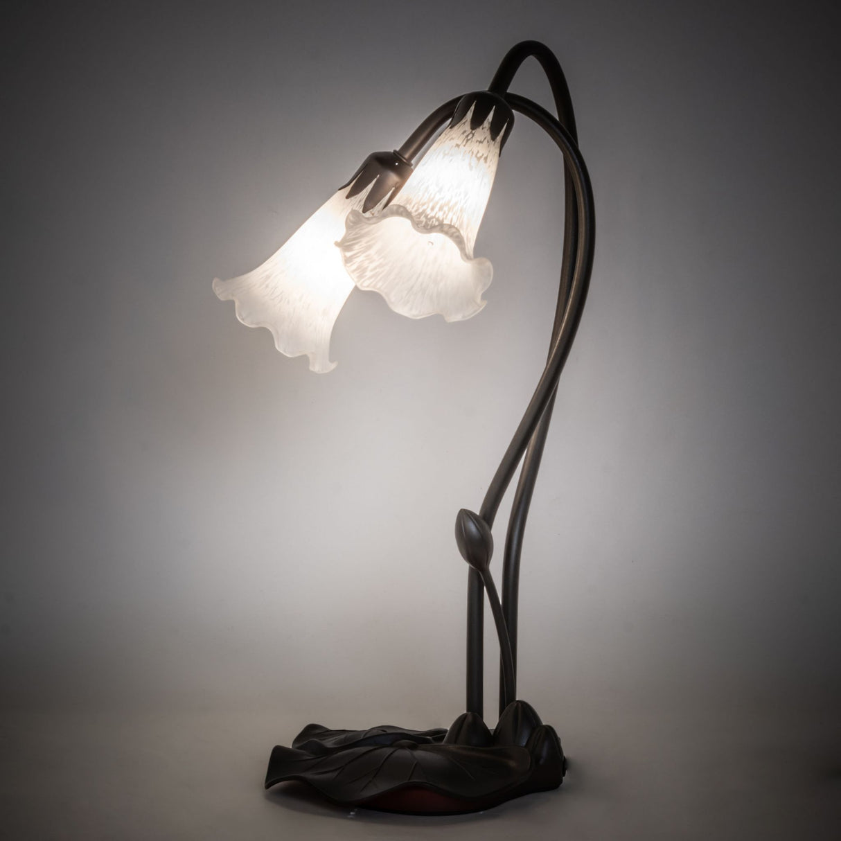 Illuminated view of the White Pond Lily accent lamp glowing with soft white tones.