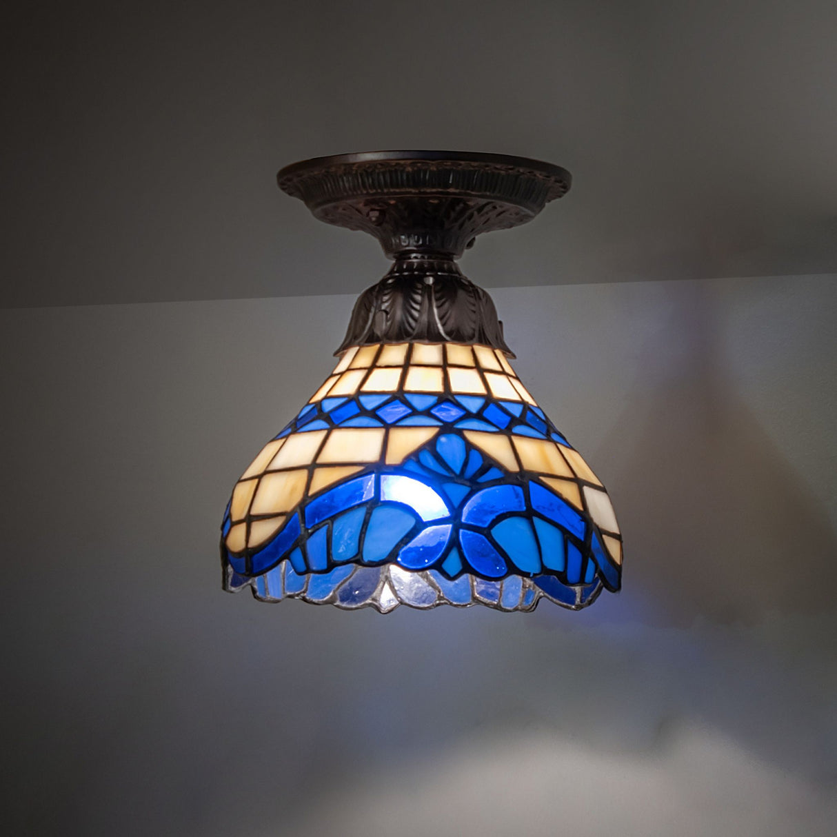 Baroque flushmount illuminated in an ambient setting.