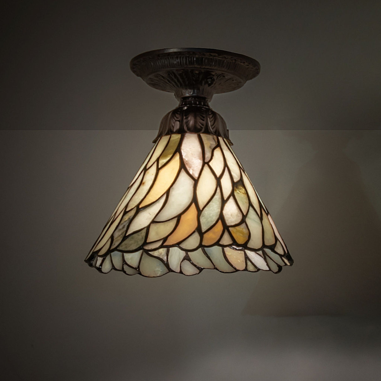 An 8" wide Willow Jadestone semi-flush light fixture with a stained glass shade for elegant illumination.