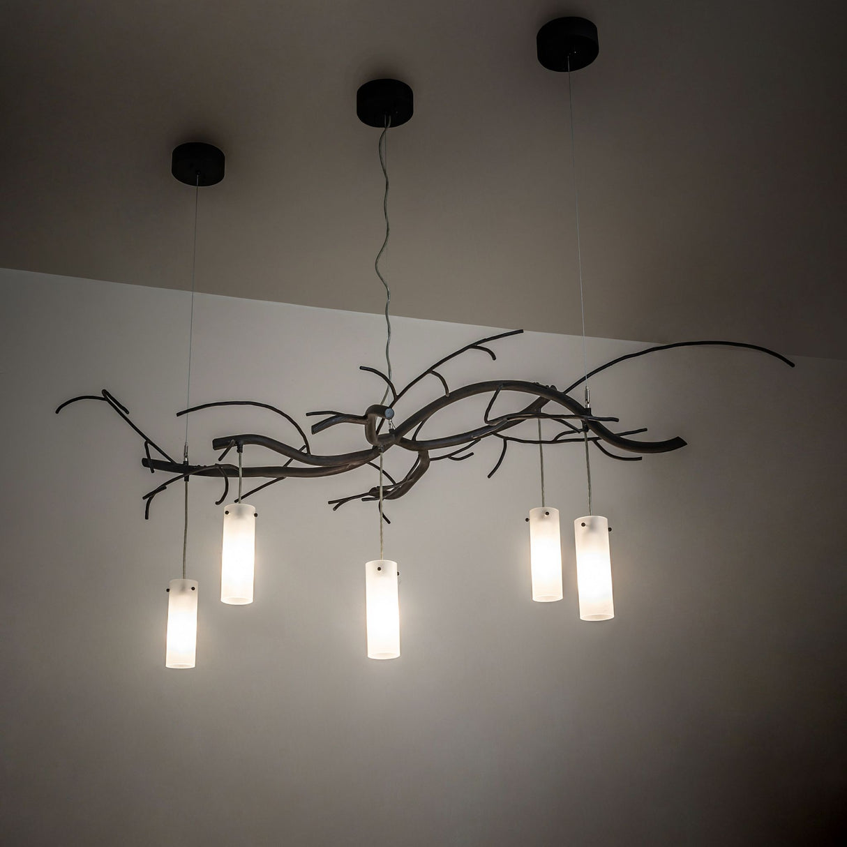Ambient view showing softly illuminated frosted glass cylinder shades.