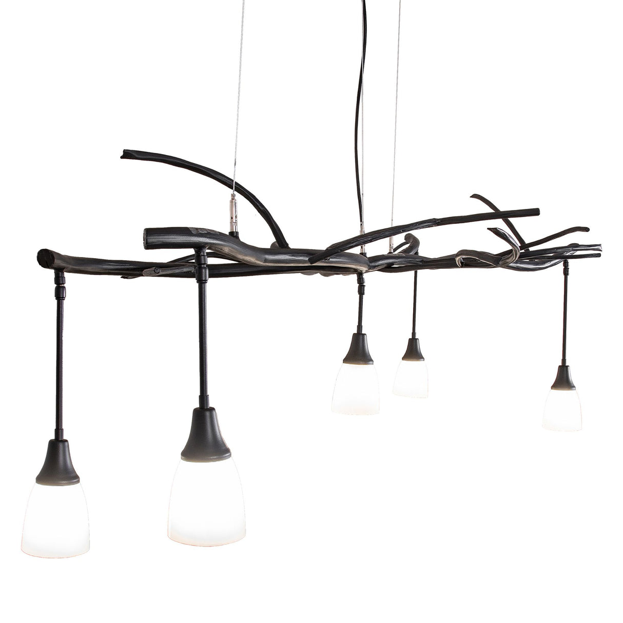 Angle view of chandelier with glass shades suspended from sculptural branch-style frame.