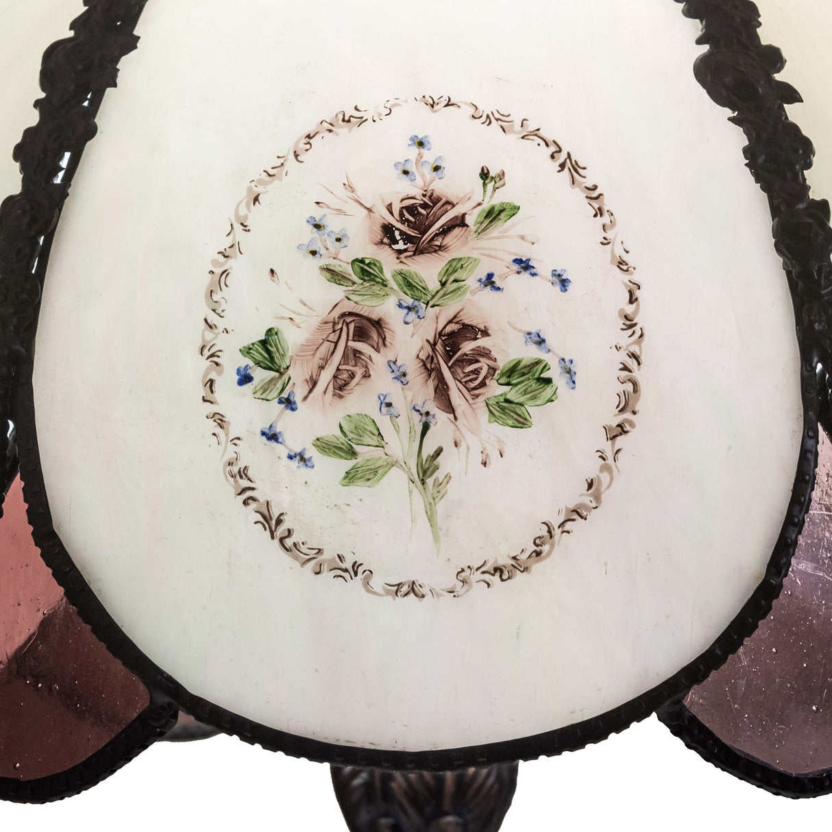 Close-up of hand-painted roses and floral detailing on the table lamp.