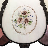 Close-up of hand-painted roses and floral detailing on the table lamp.