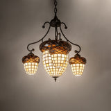 Ambient view of 4-light chandelier, lit in room setting with warm glowing stained glass shades.