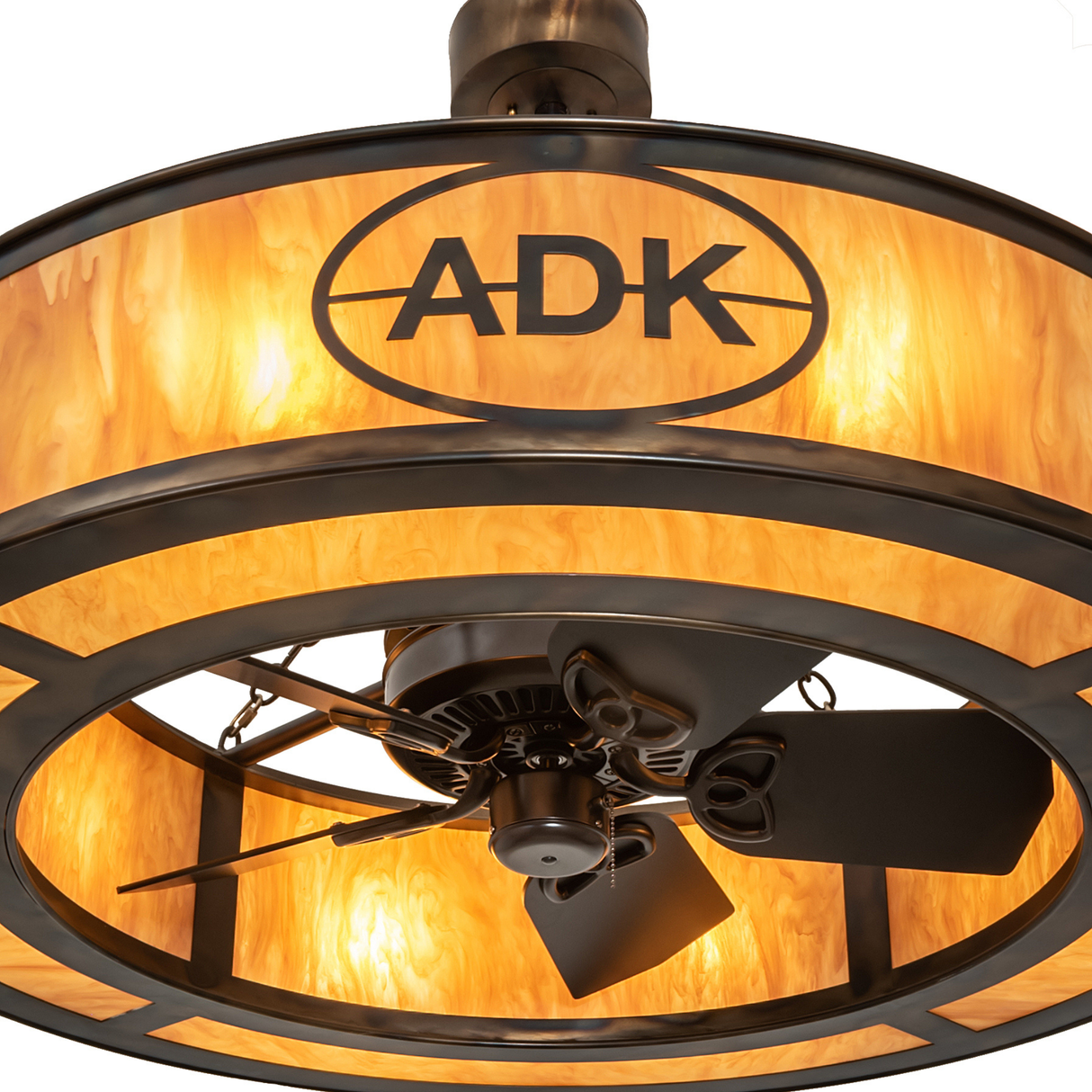 Close-up of ADK logo and bronze frame over glowing amber diffuser.