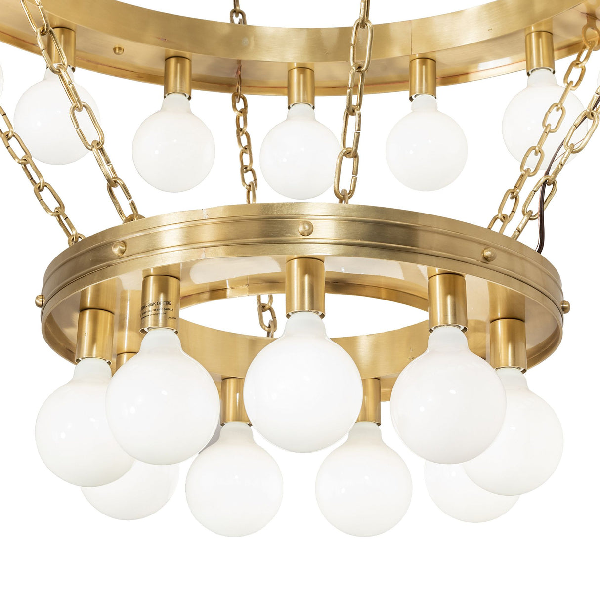 Albion chandelier close-up of lower brushed brass ring with globe bulbs.