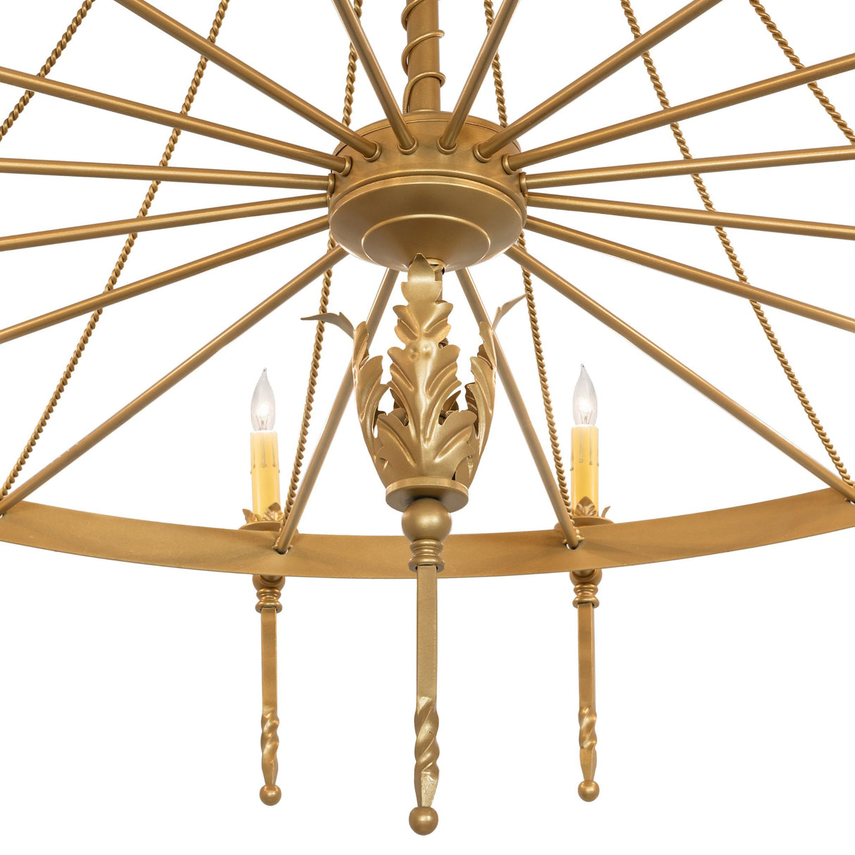 Close-up of chandelier center hub with decorative gold leaf accent and radial metal spokes.