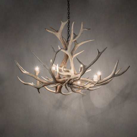 Elk antler chandelier softly illuminated in an ambient room.