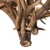 Close-up of natural elk and mule deer antlers showing rich texture and handcrafted detail.