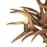 Close-up of candle-style bulb mounted in antler for warm ambient illumination.