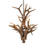 Lit view of deer antler chandelier casting warm rustic light in cabins and lodge-style interiors.
