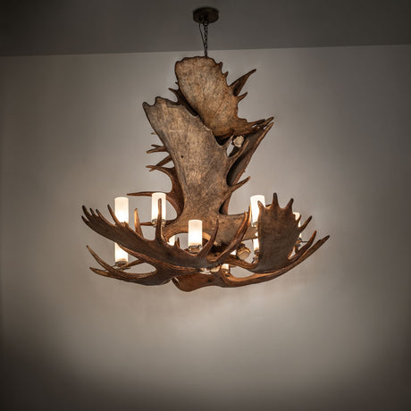 Antlers moose chandelier in ambient room lighting showing rustic texture and layered antler form.