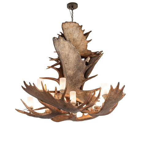 Lit view of antlers moose chandelier with warm glowing frosted glass cylinders.