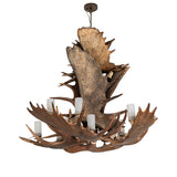 Unlit view of chandelier showing natural antler finish and clear seeded glass cylinders.