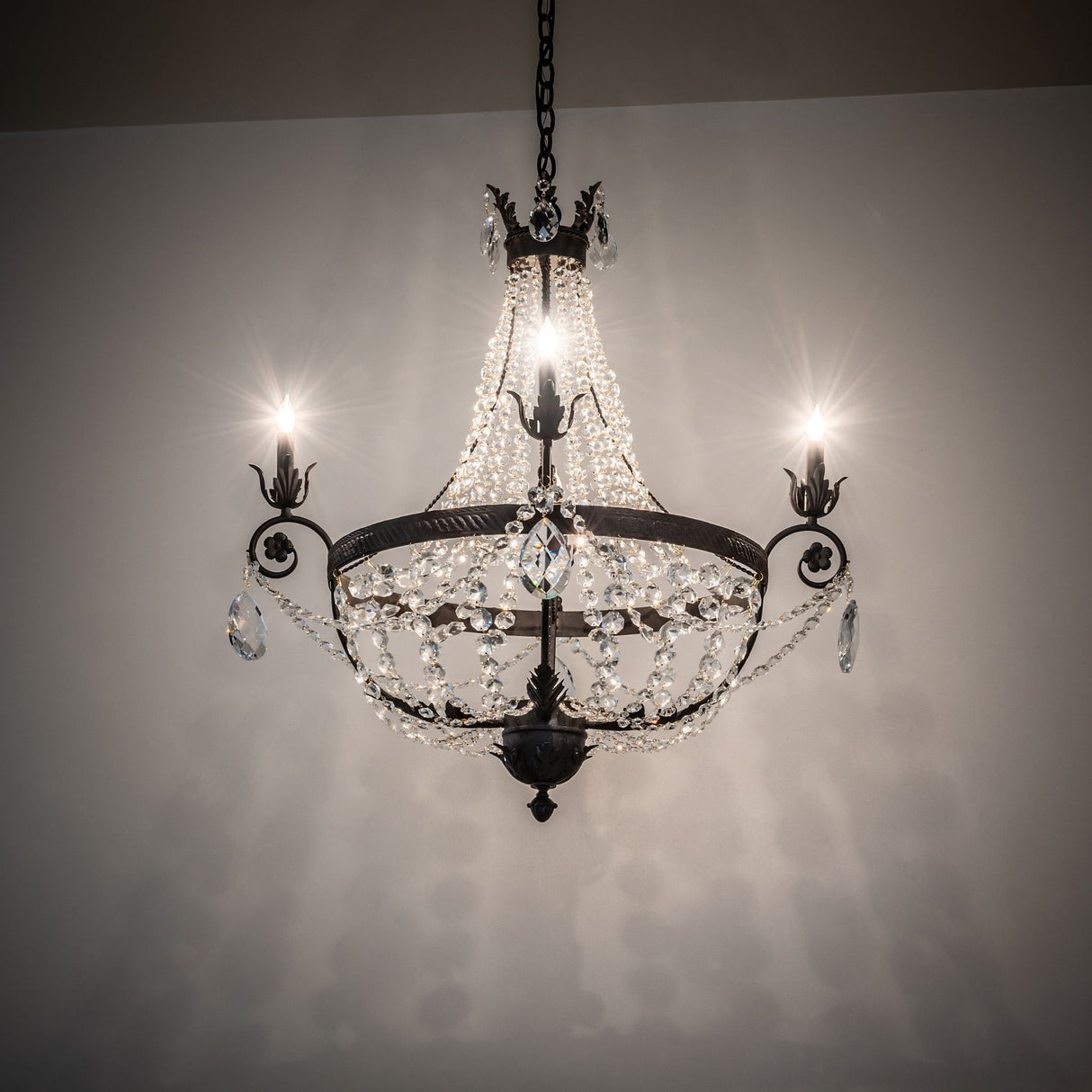 Antonia 4-light crystal chandelier illuminated in ambient room setting.