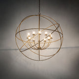 Atom style gold chandelier softly glowing in ambient room lighting.