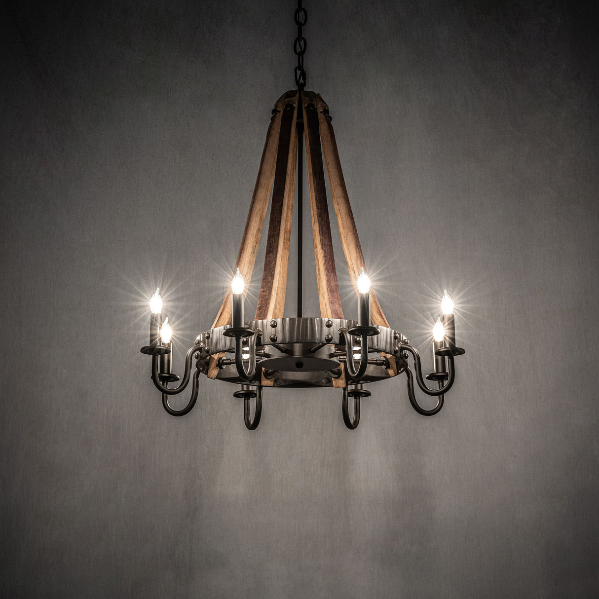 Barrel Stave chandelier providing warm ambient lighting in dark room.