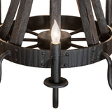 Closeup of chandelier highlighting charred wood texture, metal rivets, and candle bobeches.