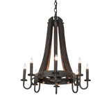 Lit view of chandelier featuring charred wood staves, black metal arms, and glowing candle lights.
