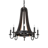 Unlit chandelier showcasing charred wood bands, metal hoop details, and candle-style sockets..