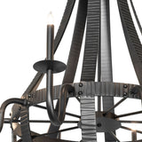 Close-up of candle-style light and curved wrought iron arm detail.