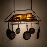 Bear at Lake lighted pot rack glowing warmly in a dark room.
