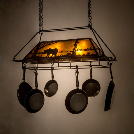 Bear at Lake lighted pot rack glowing warmly in a dark room.