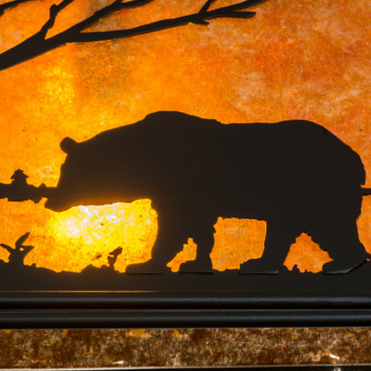 Close-up of bear silhouette and glowing amber mica panel.