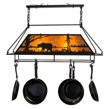 Lodge-style Bear at Lake pot rack glowing with amber illumination.